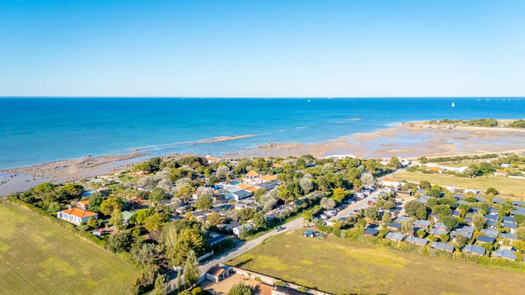 an aerial view of a beach with houses and the ocean at Camping Paradis 4 étoiles A La Corniche La Rochelle Angoulins in Angoulins-sur-Mer