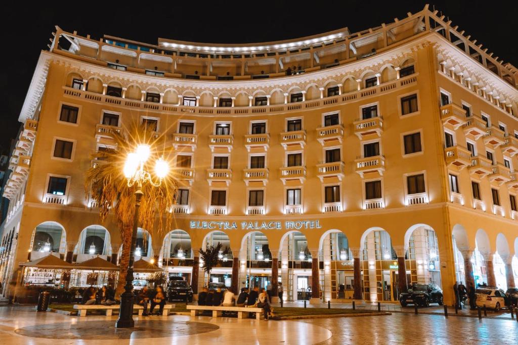 a large yellow building with a sign on it at Electra Palace Thessaloniki in Thessaloniki