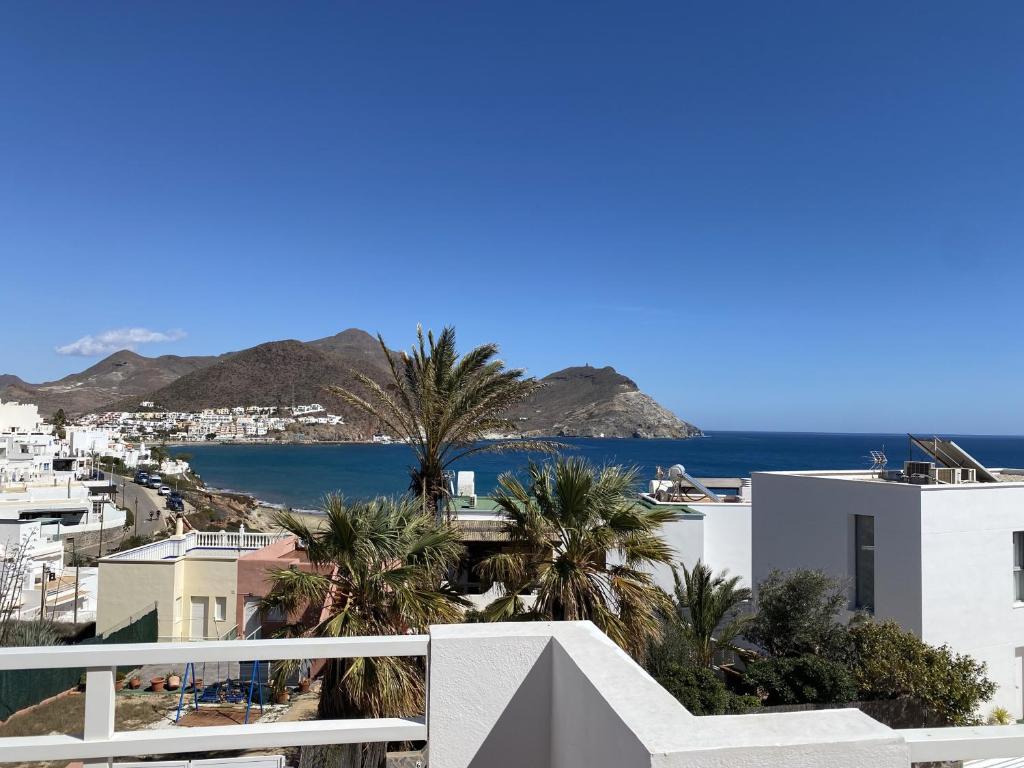 a view of the ocean from the balcony of a house at Apartahotel Vistamar San José in San José