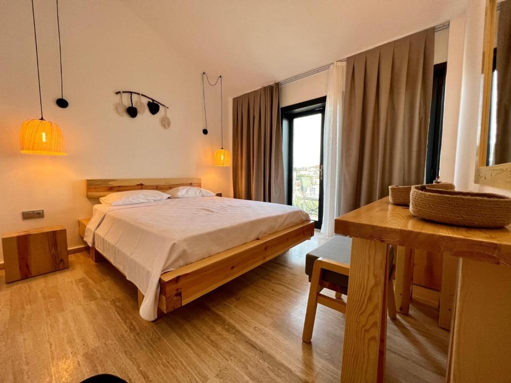 a bedroom with a bed and a large window at The Bay View Boutique Hotel Kalkan in Kas