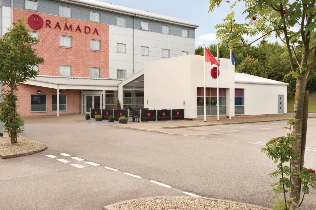 a large building with a sign on the side of it at Ramada Wakefield in Wakefield