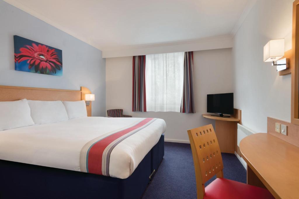 Postel nebo postele na pokoji v ubytování Ramada Wakefield