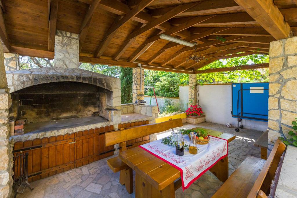 an outdoor patio with a table and a stone oven at AKELAVA in Crikvenica