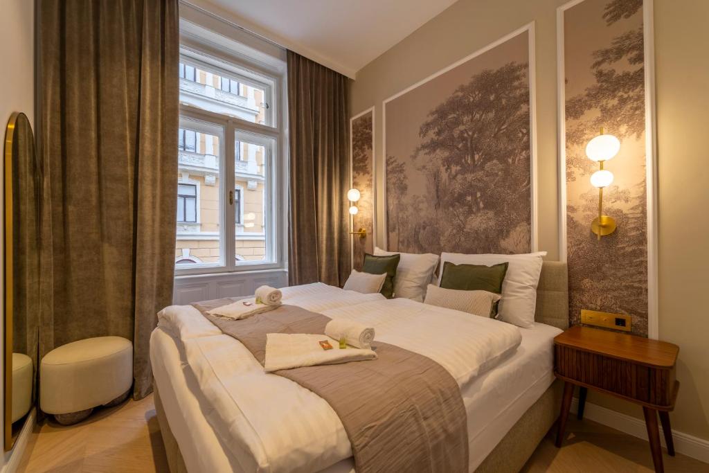 a bedroom with a large white bed with a window at josef's home I Superior Suite I Quiet & Central in Vienna