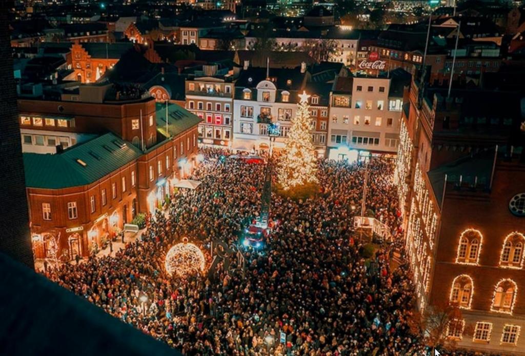 an overhead view of a crowd of people at a christmas market at City House in Odense