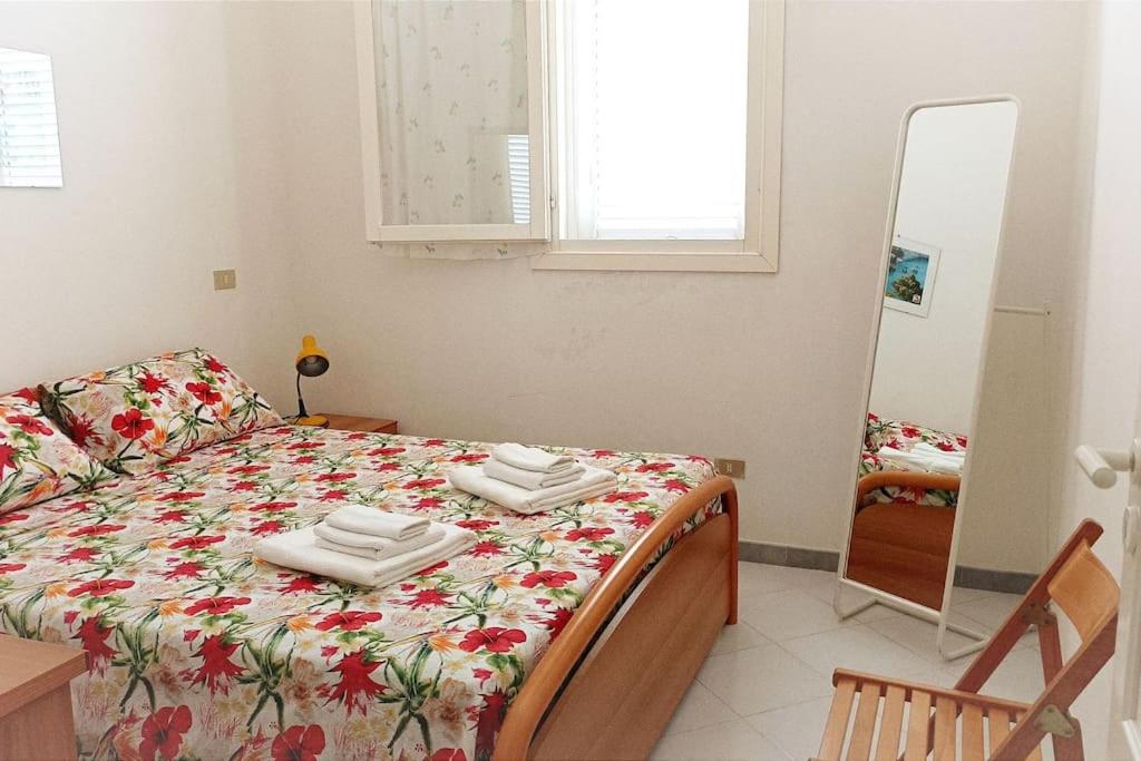 a bedroom with a bed with towels on it at Villa Valchiria in Campomarino