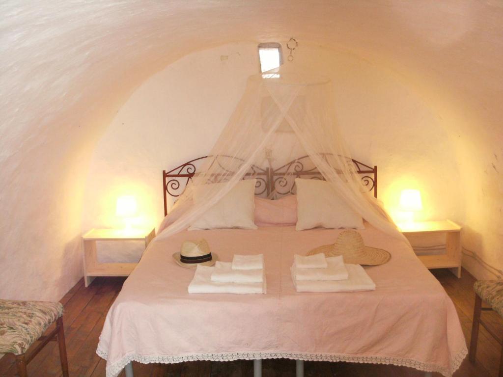 Postel nebo postele na pokoji v ubytování Trulli e Masseria Ianella