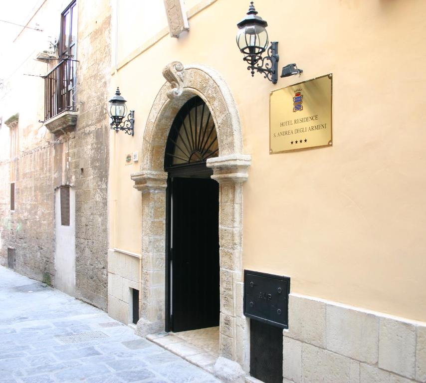 an entrance to a building with a black door at S.Andrea degli Armeni Dimora di Charme in Taranto