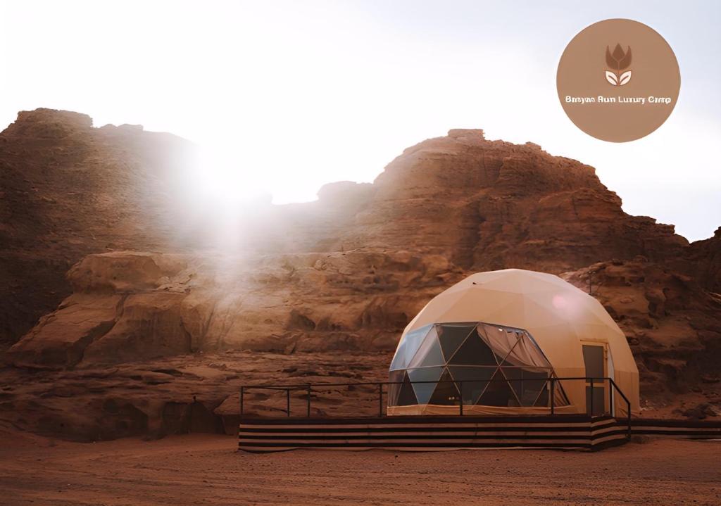 a dome tent in front of a mountain at Banyan Luxury rum Camp in Wadi Rum