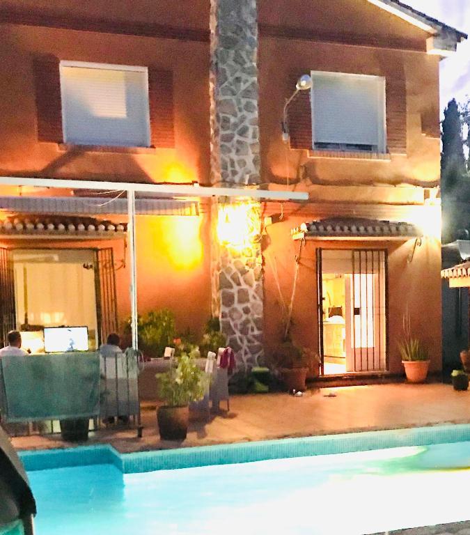 a house with a swimming pool in front of it at Villa huetor Cerca de sierra Nevada in Huétor Vega