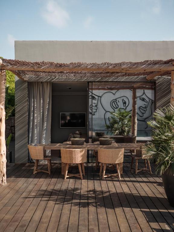 a patio with a table and chairs on a deck at OKU Ibiza in San Antonio