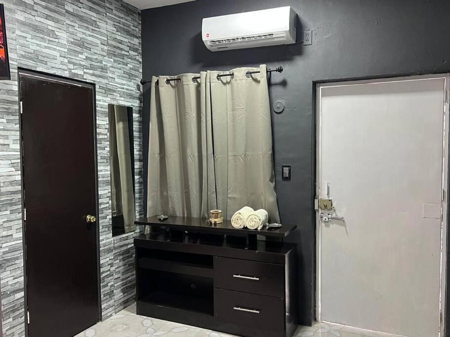 a bathroom with a sink and a mirror and a heater at Departamento PLAYA GRIS in Ciudad del Carmen