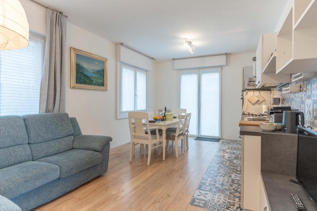 a living room with a couch and a table at La Vecchia Sartoria, Caldonazzo Ospitar in Caldonazzo