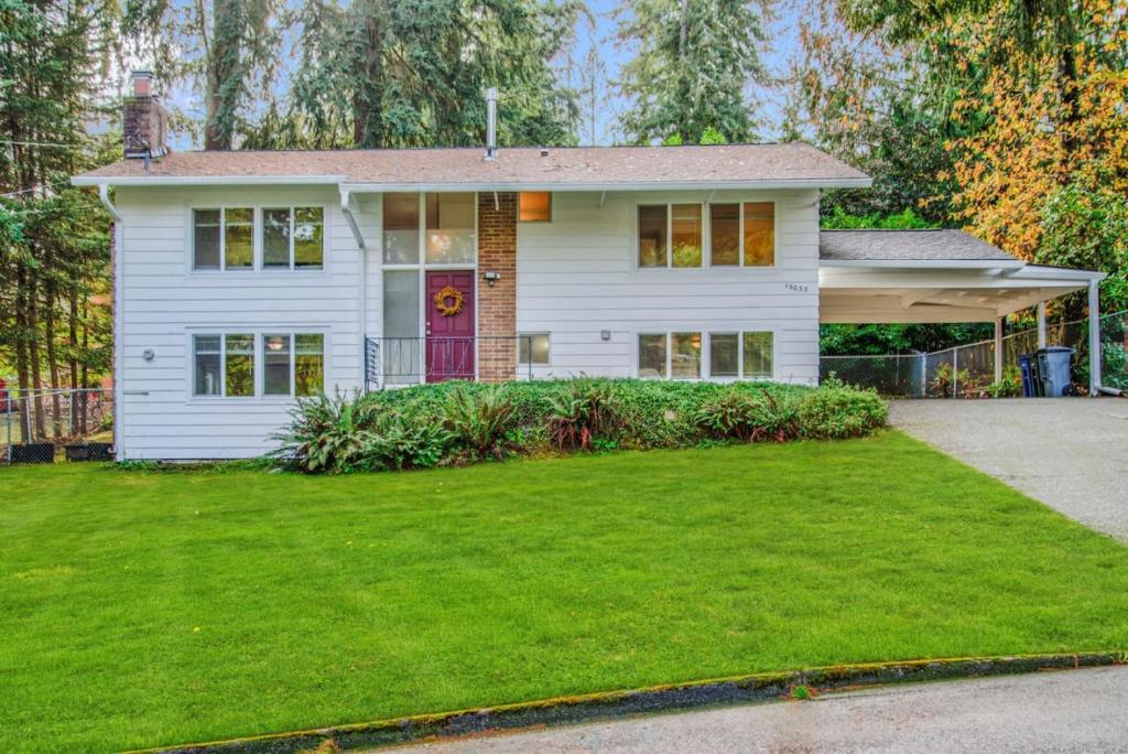 a white house with a lawn in front of it at Parkside Escape Oasis in Bellevue fully fenced in Bellevue