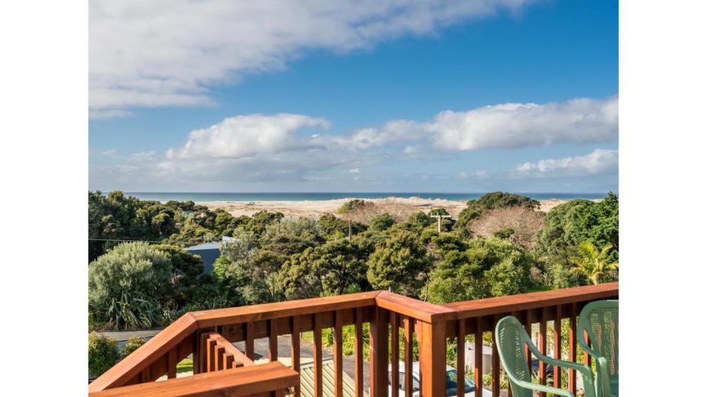 a deck with a view of the ocean at Wine Downtime - Mangawhai Holiday Home in Mangawhai