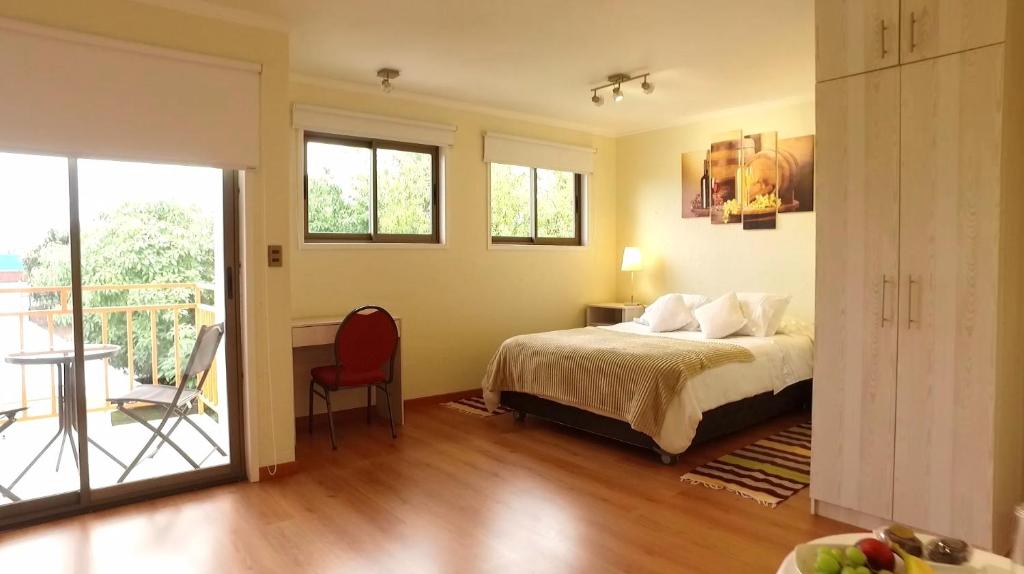 a bedroom with a bed and a balcony at Hotel San Fernando in San Fernando