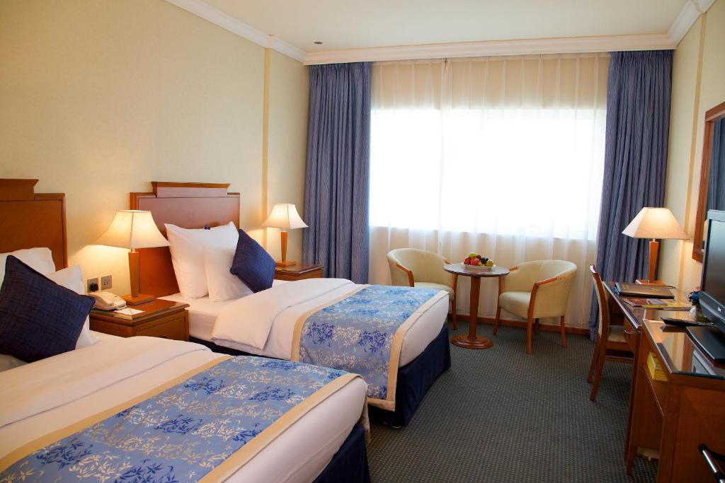 Postel nebo postele na pokoji v ubytování Lavender Hotel Sharjah