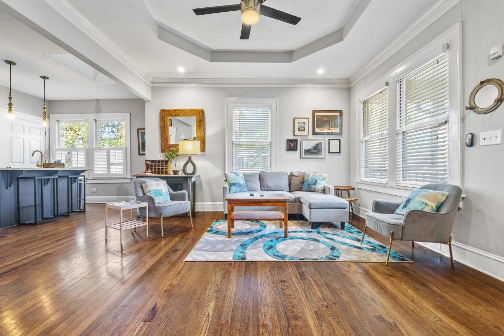a living room with a couch and chairs and a table at 1920s Bungalow with King bed WIFI Fenced backyard in Atlanta