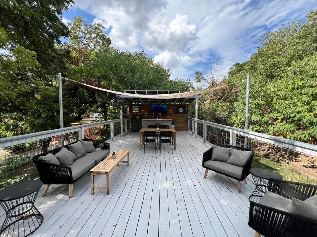 a deck with couches and a table and chairs at Authentic Austin Pad with Roof-top Deck Bar in Austin