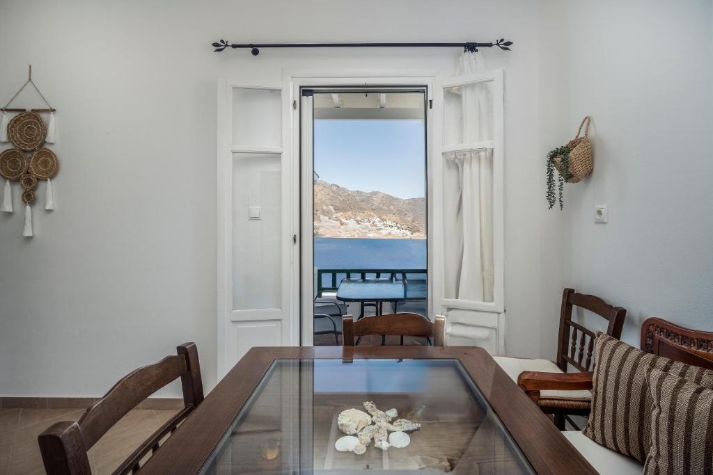 a living room with a table and a view of the ocean at Astrio Suites in Livadi