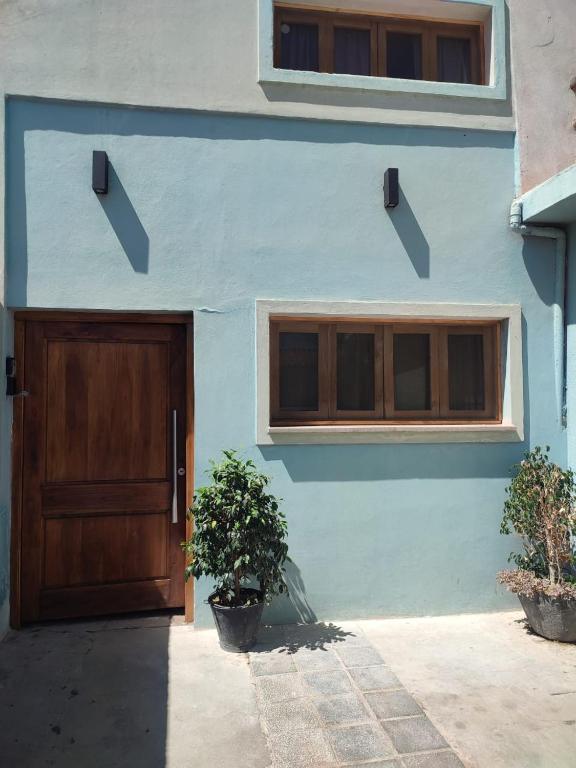 卡法亚特Casa Manipa -3 dormitorios的一栋蓝色的房子，木门，两扇窗户。