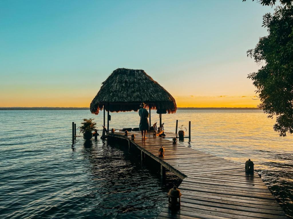 a group of people on a dock in the water at La Lancha by Francis Ford Coppola in El Remate
