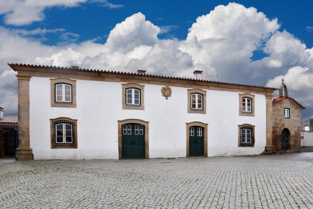 
a building with a clock on the front of it at Casa da Fidalga - Villa of 5 bedrooms in Outeiro de Gatos

