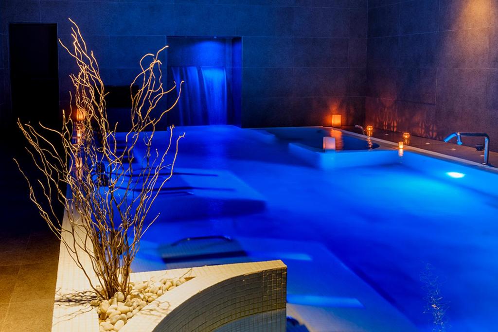 a room with a bath tub with a plant in it at miKasa Agua Amarga & SPA in Agua Amarga