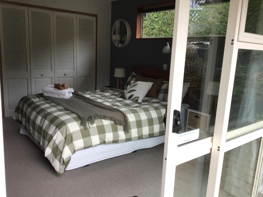 a bedroom with a bed and a window at Self contained and private room in Dunedin