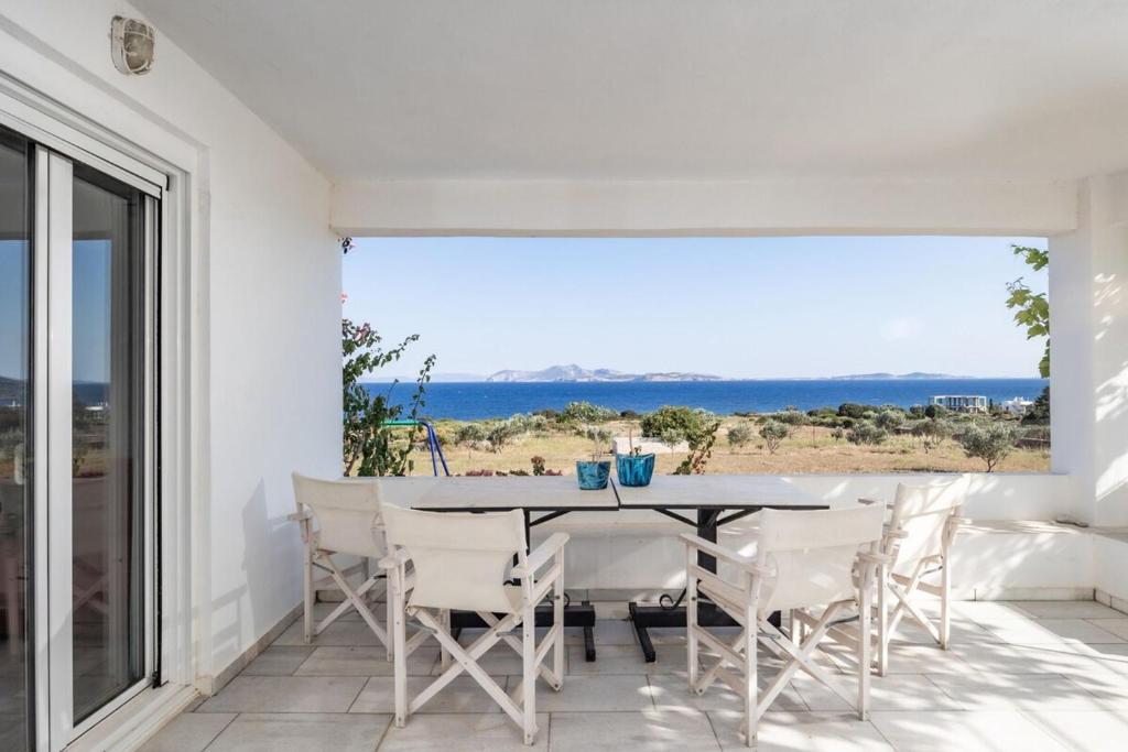 a dining room with a view of the ocean at Marathitis cottage house - Aegean sea view in Kanakis