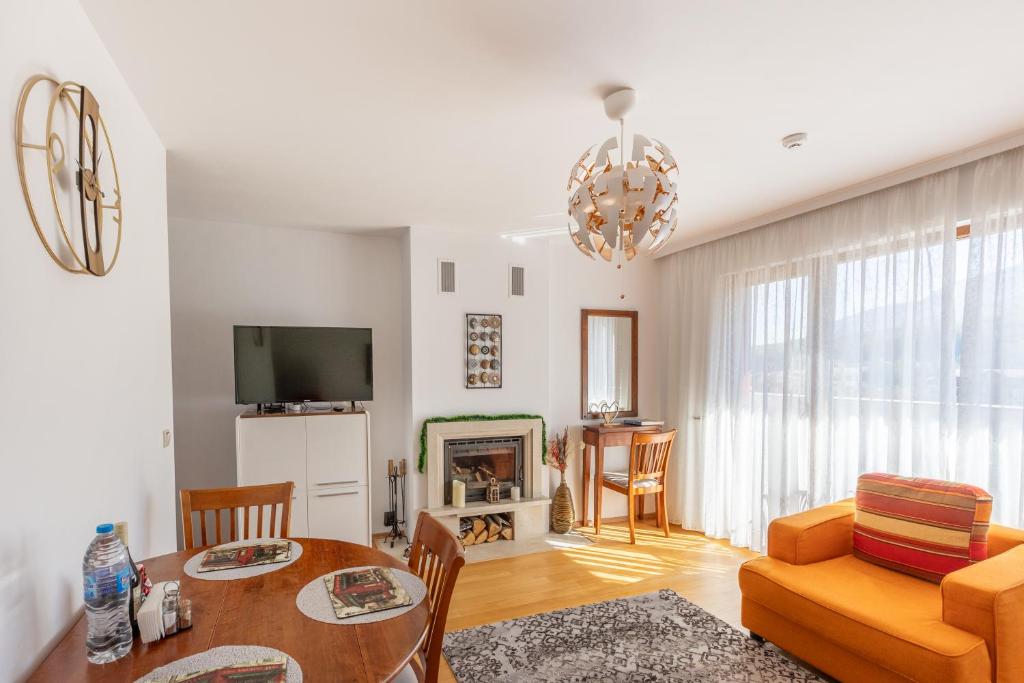 a living room with a table and a couch at One Bedroom Apartment Pirin Lodge in Bansko
