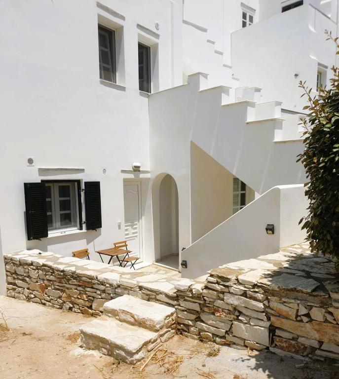 a white building with stairs on the side of it at Mary & Jo's Studios in Naxos Chora
