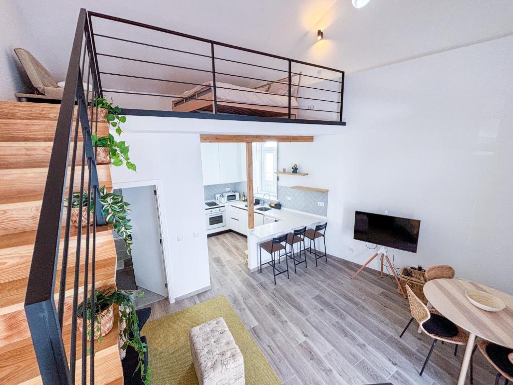 a loft apartment with a staircase and a living room at Sweet Home Cascais in Cascais