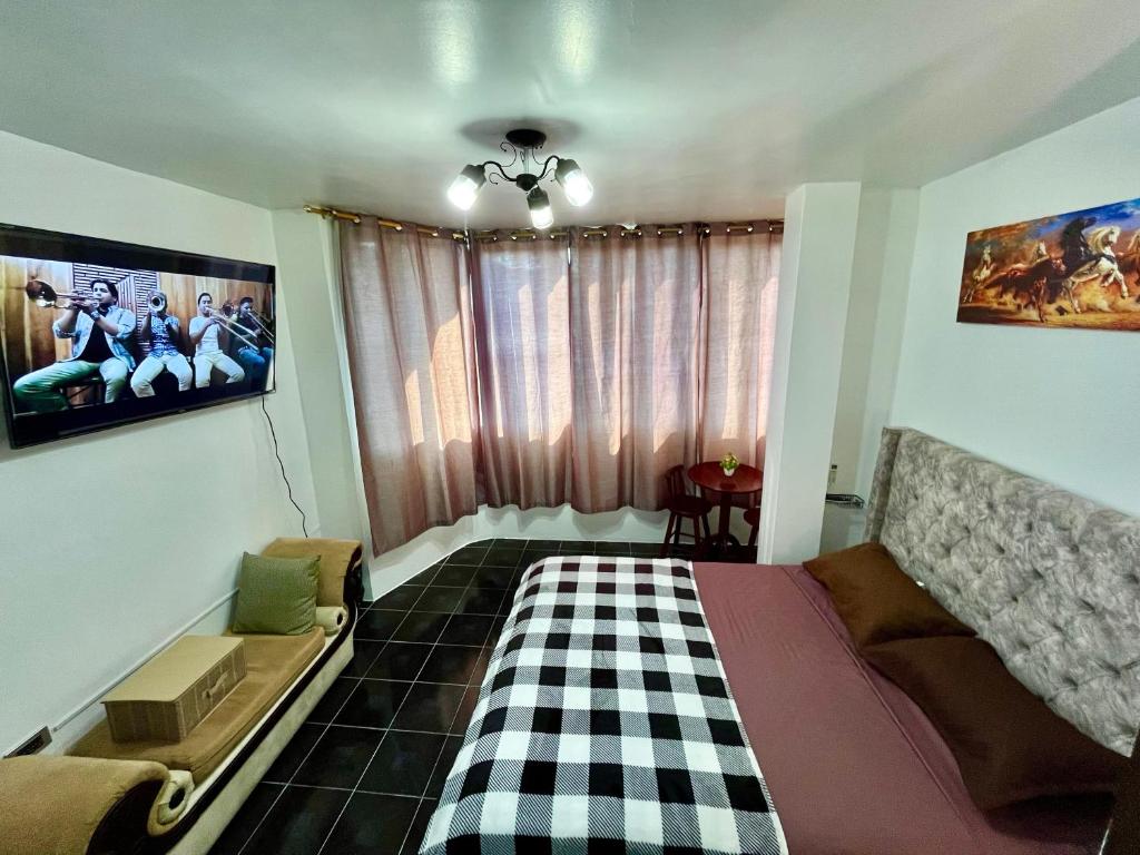 TV a/nebo společenská místnost v ubytování Suite Deluxe - 4 min Consulado Americano