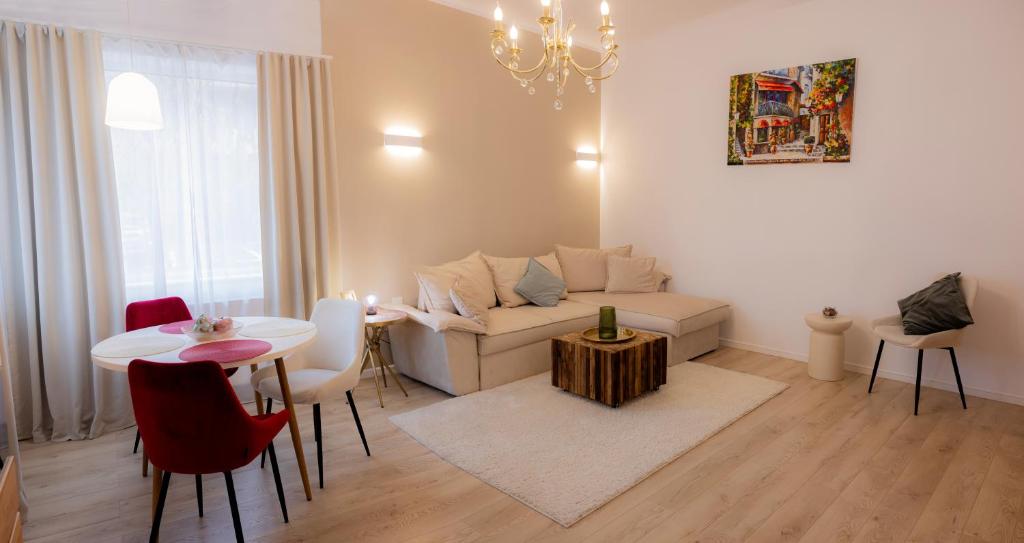 a living room with a couch and a table at Homey Luxury- entire house, free parking, yard in Cluj-Napoca