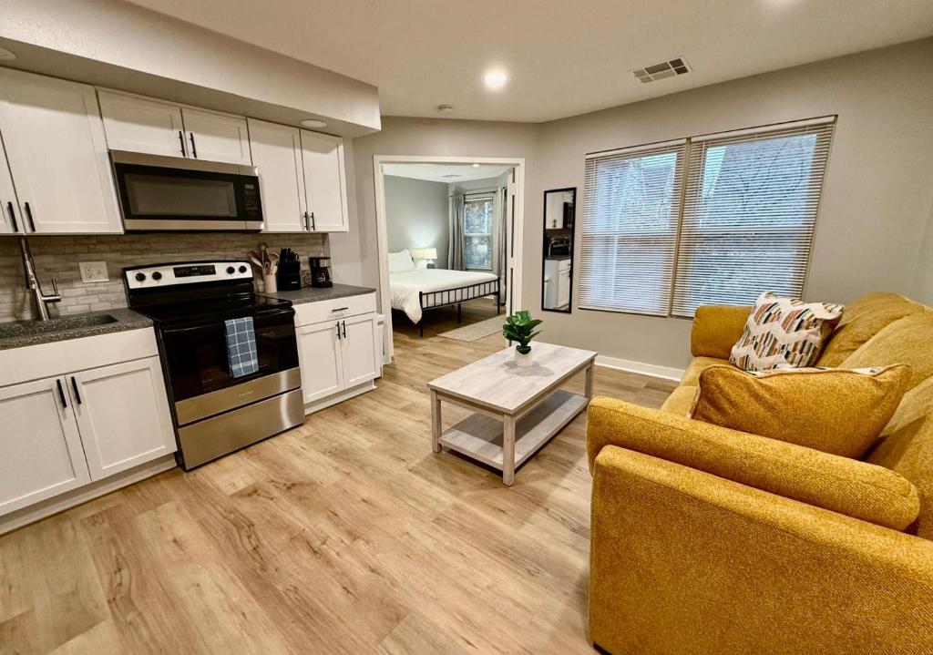 a kitchen and living room with a couch and a table at Aksarben Gem near UNO in Omaha