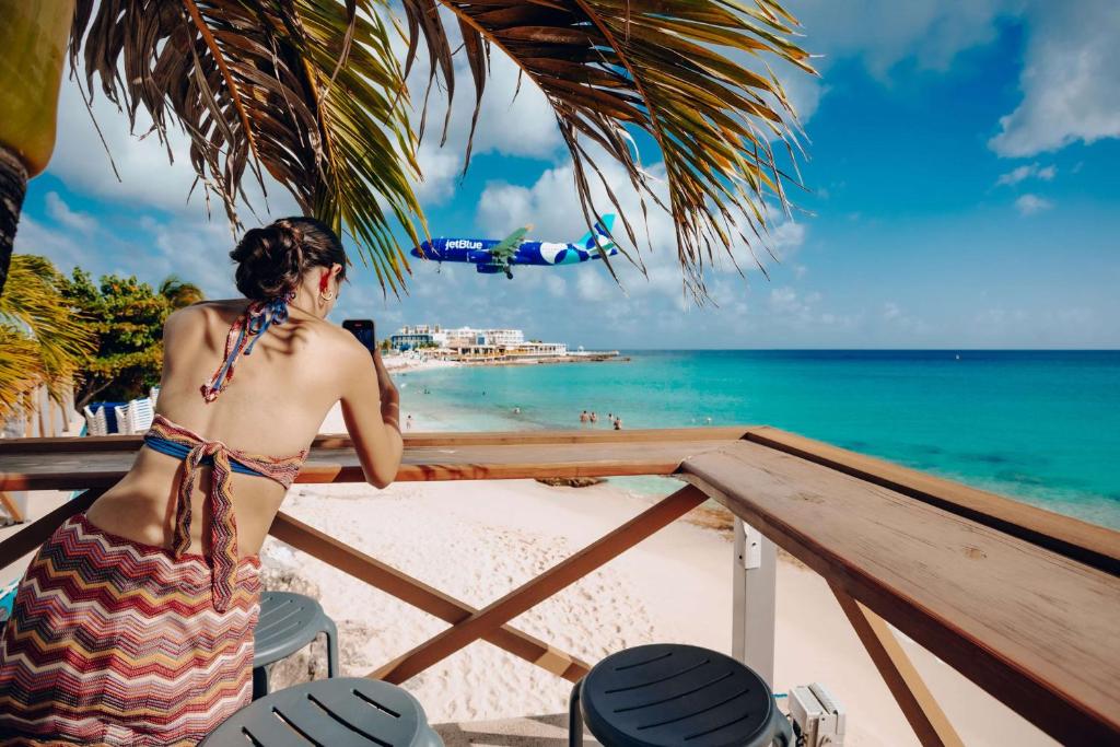 a woman in a bikini looking at the beach at Royal Islander Club Resort La Plage in Lowlands