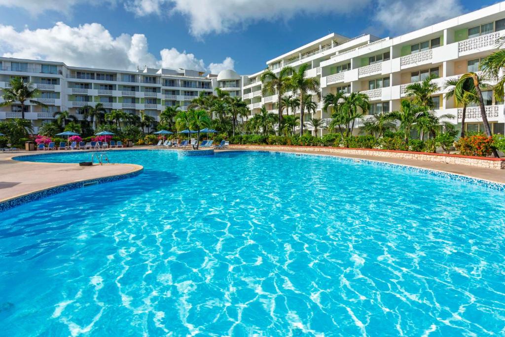 a large swimming pool in front of a hotel at Royal Islander Club Resort La Plage in Lowlands