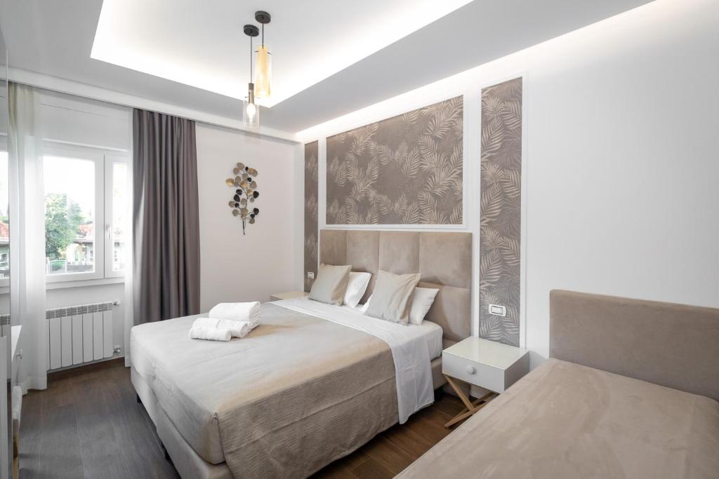 a hotel room with two beds and a window at La Genziana in Rome