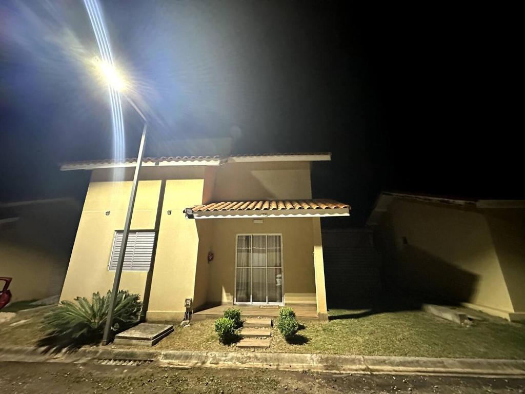 a small house with a street light in front of it at Chalé catarina home clube in Mairinque