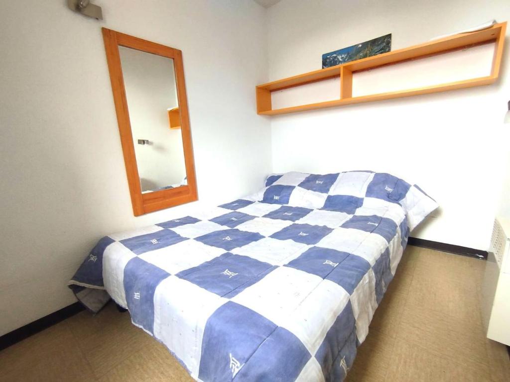 - une chambre avec un lit à damiers bleu et blanc dans l'établissement Résidence Aurans - Appartement T2 6 personnes centre station Réallon 339A MAE-8791, à Réallon