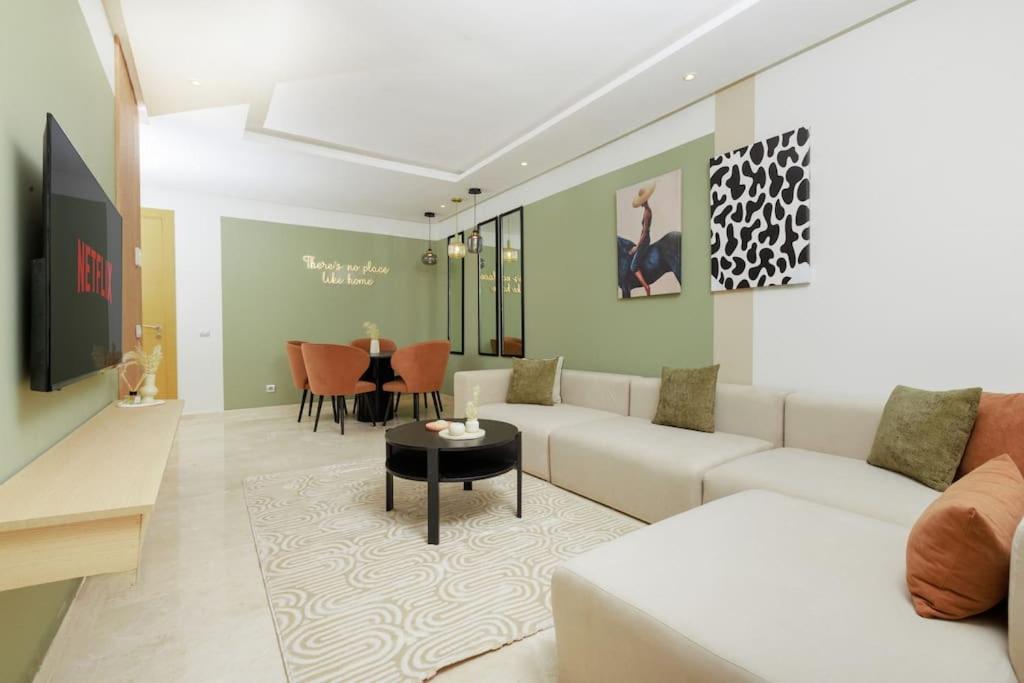 a living room with a couch and a table at Luxury 3BR Homelike Stay in Hay Riad in Rabat