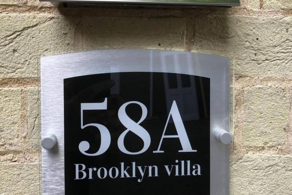 a sign on the side of a brick wall at Brooklyn Villa in Norwich