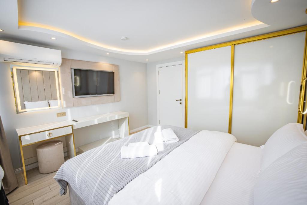 a bedroom with a white bed and a television at ISTANBUL SUITE in Istanbul