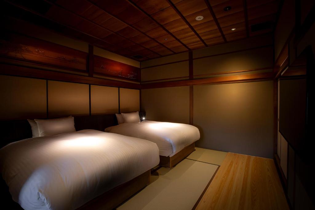 Postel nebo postele na pokoji v ubytování Hotel Utano Kyoto Besho