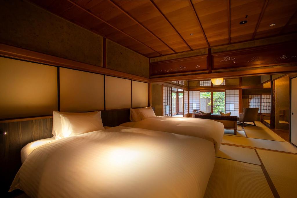 Postel nebo postele na pokoji v ubytování Hotel Utano Kyoto Besho