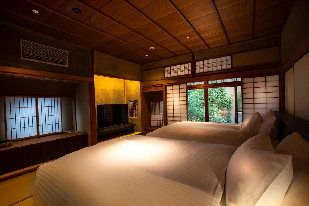 Postel nebo postele na pokoji v ubytování Hotel Utano Kyoto Besho