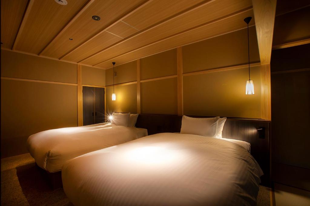 Postel nebo postele na pokoji v ubytování Hotel Utano Kyoto Besho