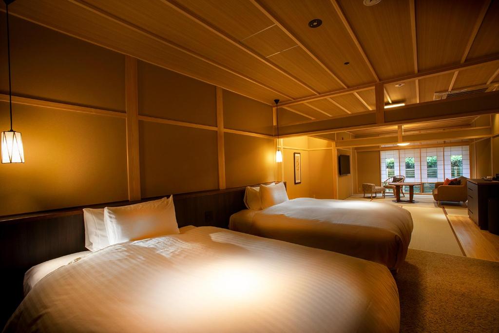 Postel nebo postele na pokoji v ubytování Hotel Utano Kyoto Besho