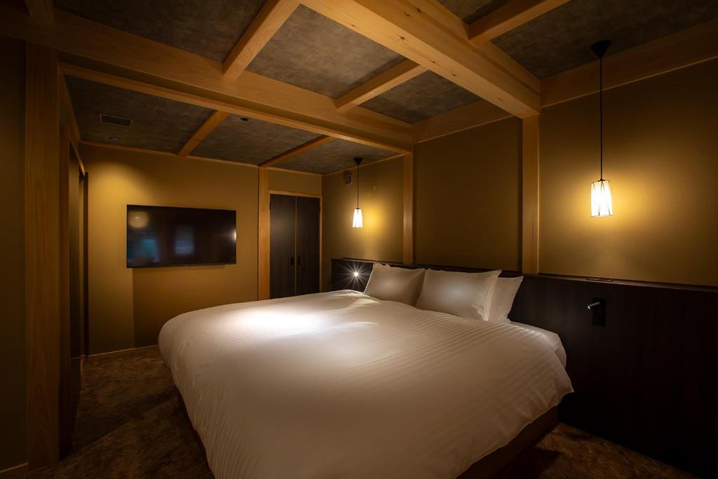 Postel nebo postele na pokoji v ubytování Hotel Utano Kyoto Besho